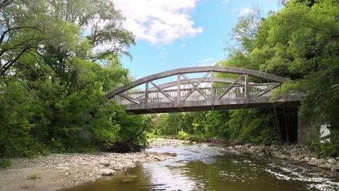 In the forest with old bridge in background and river flowing beneath Stockbeeldmateriaal 133643939