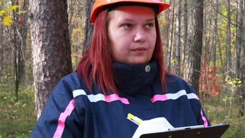 Forest researcher conducts field study in vibrant autumn landscape 스톡 동영상 295247651