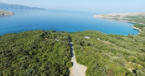 Forest with road down the middle opening to the beach at sea Stock Footage 119518911