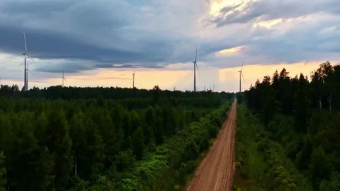 Forest Road Through Wind Farm Beneath Storm Clouds Stock Footage 341764072