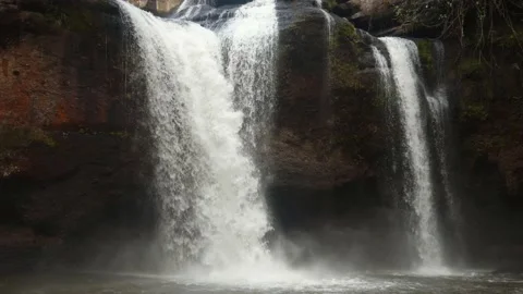 Forest rocks with moss and roaring stream. Haew Suwat waterfall in Thailand Video stock 165549353