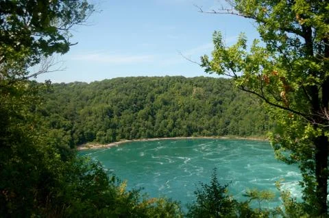 Forest, rough river, strong current, Cliff, Sunny day Stock Photos