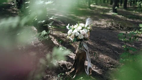 In the forest, through the branches of trees, you can see a bouquet of flowers Stock Footage 171026700