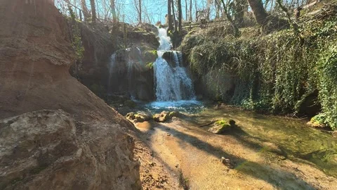 Forest Waterfall with Turquoise Pool and Golden Rocks Vídeo Stock 330676994