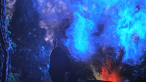 A forest witch brews a potion holding a Voodoo doll Video stock 133208145