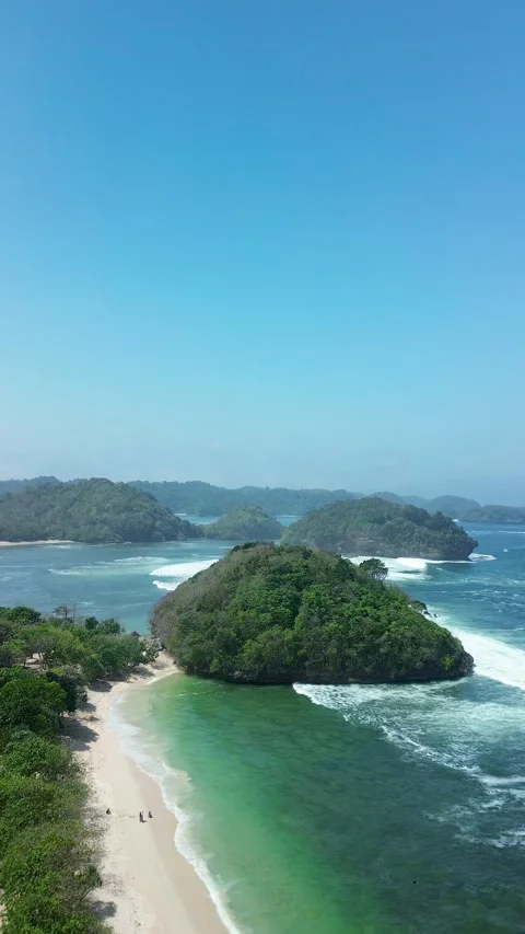 Forested island Teluk Asmara Beach vertical view August 3 2026 Video stock 342146589