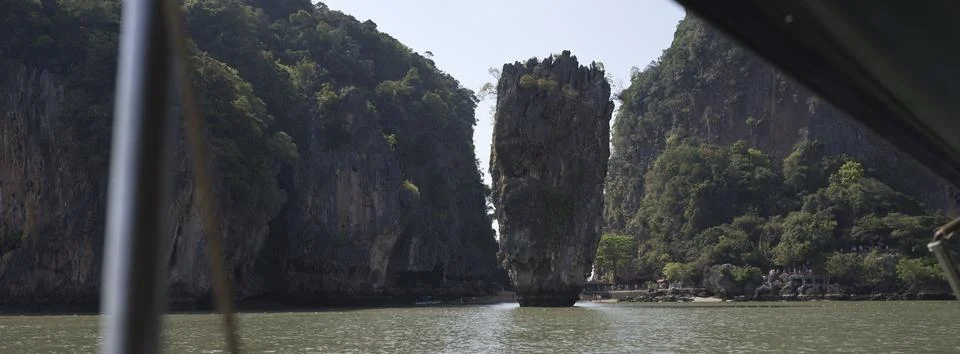 Forested limestone cliffs with a narrow gap, Thailand Stock Photos