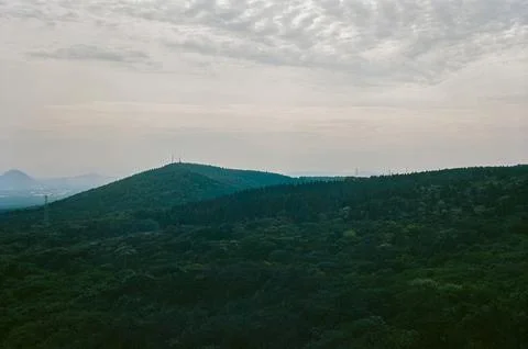 Forested Mountain Landscape Under a Dramatic Cloudy Sky Stock Photos