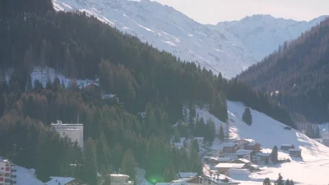 Forested mountain slopes above the Davos valley in winter Stock Footage 345299473