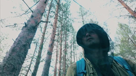 A forester, dressed in protective clothing, explores the taiga. Video stock 310266414