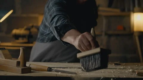 Forester, Workshop Worker Cleaning the workplace. Carpenter's brush sweeps a Stock Footage 242993776