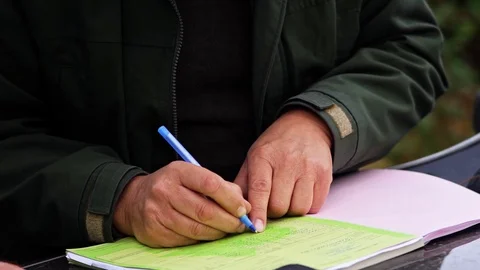 Forester Writing Sheet of Paper From Front Close Up Detail Vídeo Stock 128491691