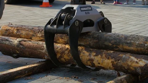 A forestry machine loads a log truck at the site landing. Forest machine down Stock Footage