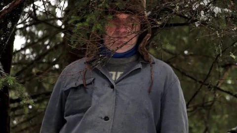 Forestry worker who looks behind some dry fir branches Stock Footage 71755545