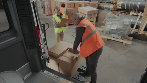Forewoman Helping Storage Worker Loading Boxes into Van Stock Footage 256066716