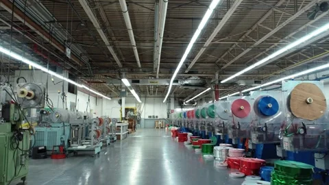 A foreword moving drone shot through a warehouse with boxes stacked on one Stock Footage 322862760