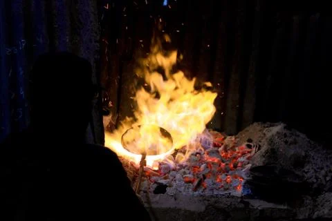 Forge fire in blacksmith's where iron tools are crafted Stock Photos