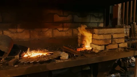 Forge fire in furnace. Blacksmith temper a steel product in a stove. Smithy f Stock Footage 121583711