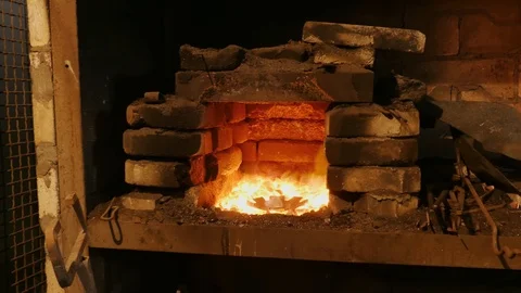 Forge fire in furnace. Blacksmith temper a steel product in a stove. Smithy f Stock Footage 121583716