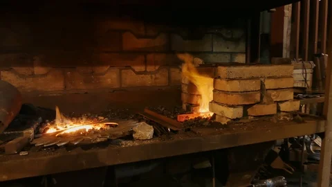 Forge fire in furnace. Blacksmith temper a steel product in a stove. Smithy f Stock Footage 121583728