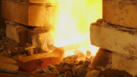 Forge fire in furnace. Blacksmith temper a steel product in a stove. Smithy f Stock Footage 121583748