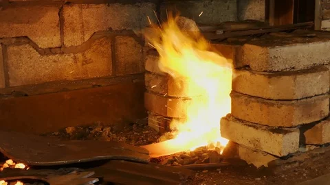 Forge fire in furnace. Blacksmith temper a steel product in a stove. Smithy f Stock Footage 121583775