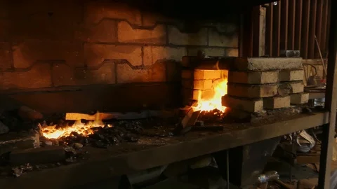 Forge fire in furnace. Blacksmith temper a steel product in a stove. Smithy f Stock Footage 121583781