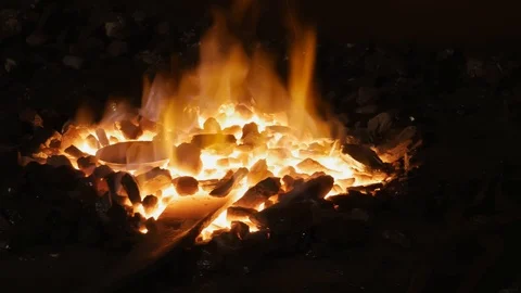 Forge fire in furnace. Blacksmith temper a steel product in a stove. Smithy f Stock Footage 121583798