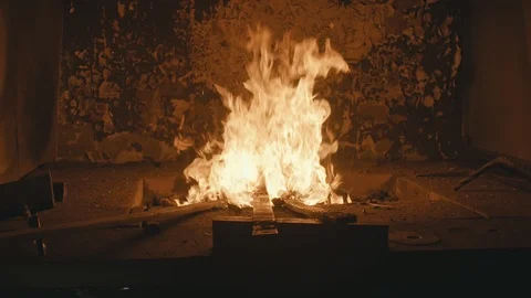 Forge fire in furnace. Blacksmith tempers a steel product in a stove. Smithy Stock Footage 121410188