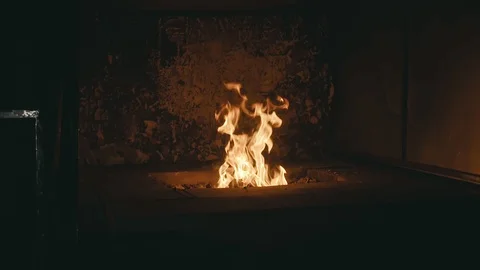 Forge fire in furnace. Blacksmith tempers a steel product in a stove. Smithy Stock Footage 121640163