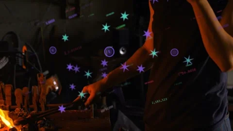 From forge flame, smith shaping metal with tongs and on phone while purple Stock Footage 333414020