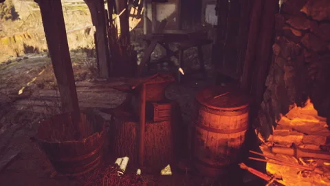 Forge tools and warm fire in traditional blacksmith workshop setting Stock Footage 331420624