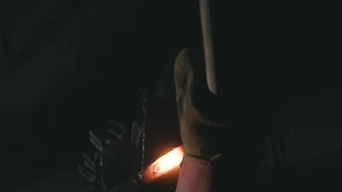 Forge workshop. Smithy manual production. Hands of smith with hammer hit on Stock Footage 121113759