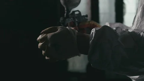 Forge workshop. Smithy manual production. A worker paints a part from a spray Stock Footage 121818126