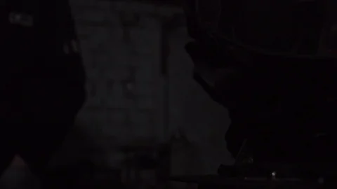 Forge workshop. Smithy. Worker in a welding hood helmet welds a part by electric Stock Footage 121121100