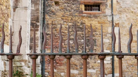 Forged curved sharp spikes of ancient iron fence with rust Stock Footage 245220177