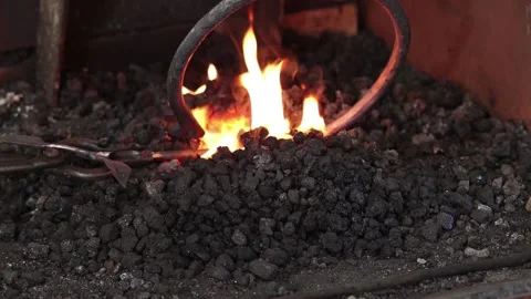 Forged iron ring heating in coal fire Stock Footage 133954247