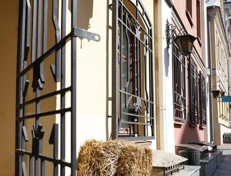 Forged iron window bars gate foreground photo. Vintage metal security grills and Stock Photos