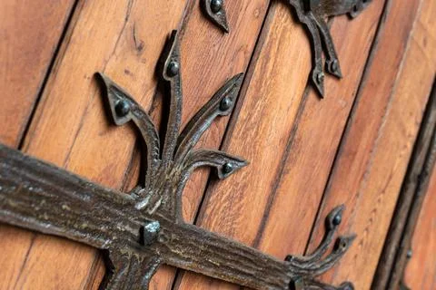 Forged pattern on door with decorative elements. Old vintage entrance, massiv Stock Photos