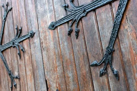 Forged pattern on door with decorative elements. Old vintage entrance, massiv Stock Photos