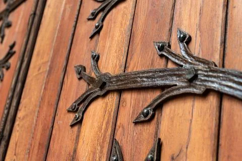 Forged pattern on door with decorative elements. Old vintage entrance, massiv Stock Photos