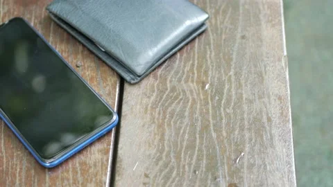 Forget smartphone on a park bench, lost smart phone Stock Footage 209612927