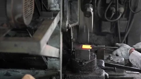 Forging a Glowing Metal Blade on a Workshop Machine Stock Footage 340009292
