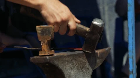 Forging hot metal in smithy. Blacksmith manually forging hot metal on the anv Stock-Footage 110836595