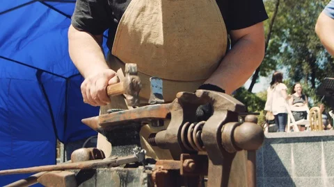 Forging hot metal in smithy. Blacksmith manually forging hot metal on the anv 動画素材 111265223