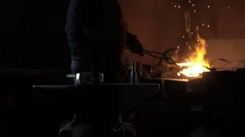 Forging hot metal in smithy Stock Footage 69860940