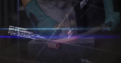 Forging metalworker in gloves holding glowing bar on anvil in workshop, with Stockfoto's