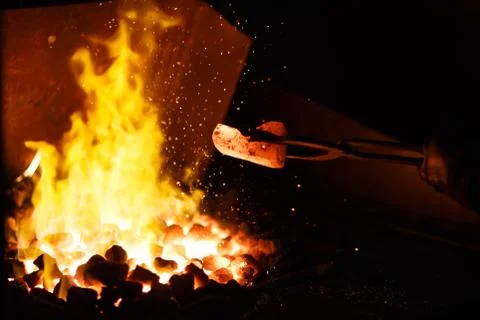 Forging the molten metal, making of an axe Stock Photos