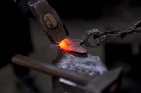 Forging the molten metal, making of an axe Stock Photos