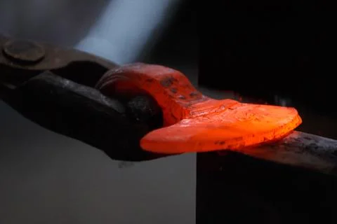 Forging the molten metal, making of an axe Stock Photos